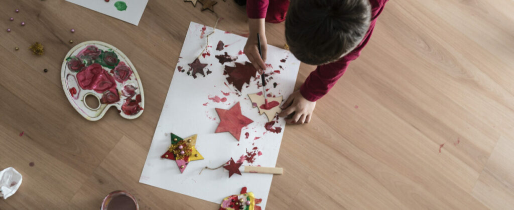 A kid doing Christmas painting decorations | MyNewFloor.com