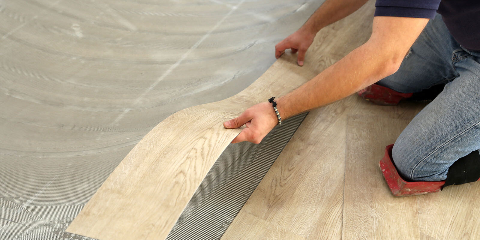 work-on-laying-flooring-worker-installing-new-vinyl-tile-floor